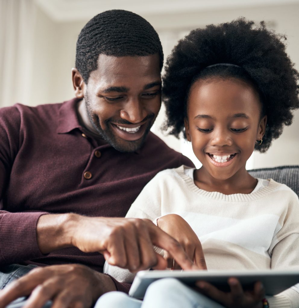 A girl reading to her dad.